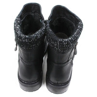 Black leather look ankle boots with grey and white knitted ankle cuffs. Low heels. Back view.
