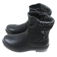 Black leather look ankle boots with grey and white knitted ankle cuffs. Low heels. Side view.