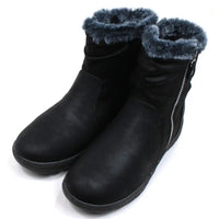 Black ankle boots by Shoes By Emma. Faux silver zips on the outside with fitting black zips on the inside of the feet and ankles. Grey fur cuffs around the ankle. Almost flat wedged soles. Angled view.