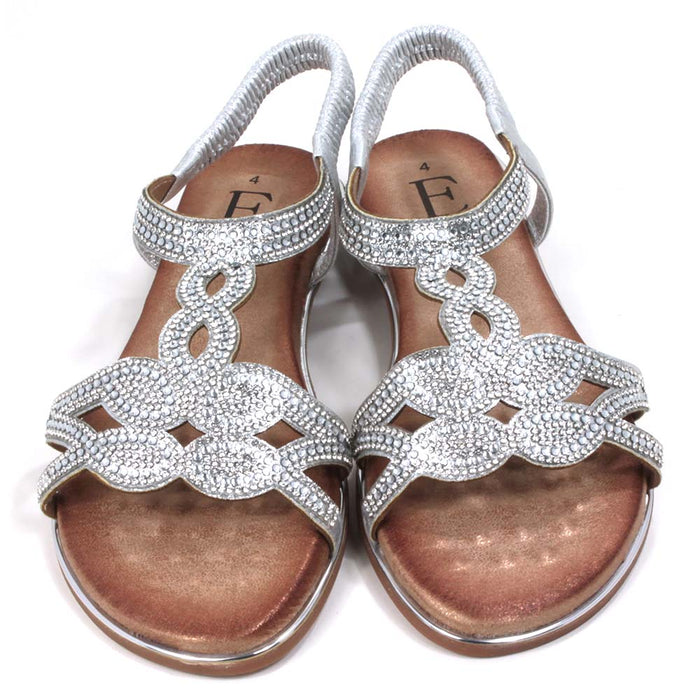 Emma silver, diamante covered sandals. Silver elasticated ankle straps. Tan coloured insoles. Silver trim around the soles. Front view.