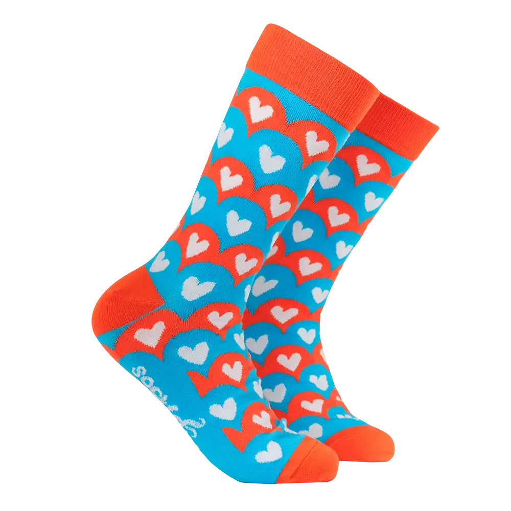 Colourful heart-patterned sock with orange accents on a white background