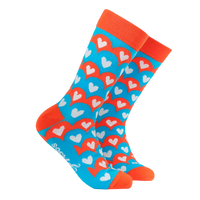 Colourful heart-patterned sock with orange accents on a white background