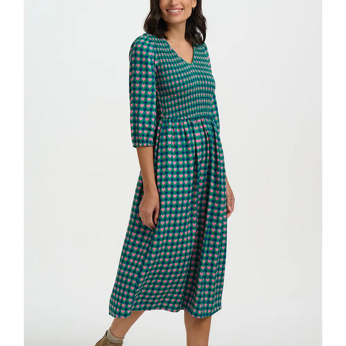 Woman wearing a green checkered dress on a white background