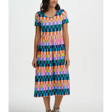 Woman wearing a colorful checkered dress on a white background