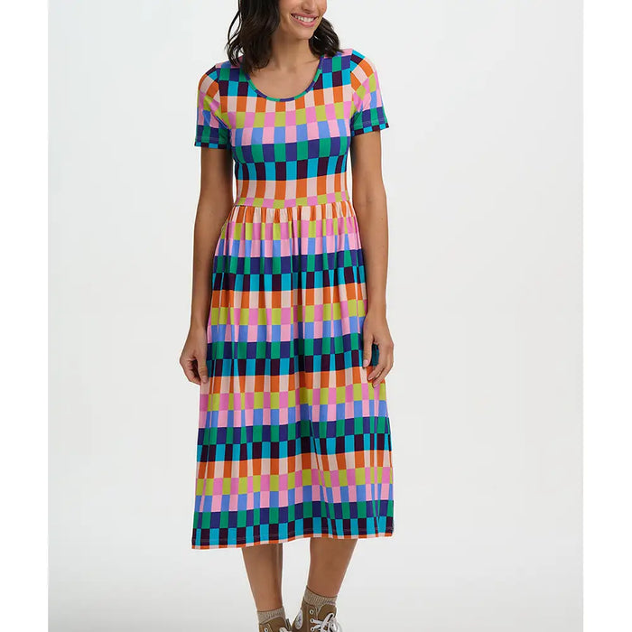 Woman wearing a colorful checkered dress on a white background