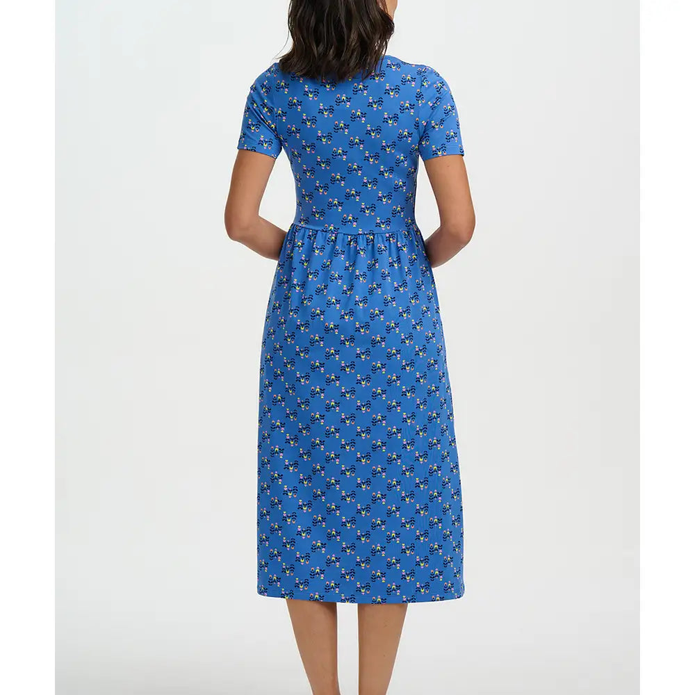 Woman wearing a blue dress with a pattern on a white background