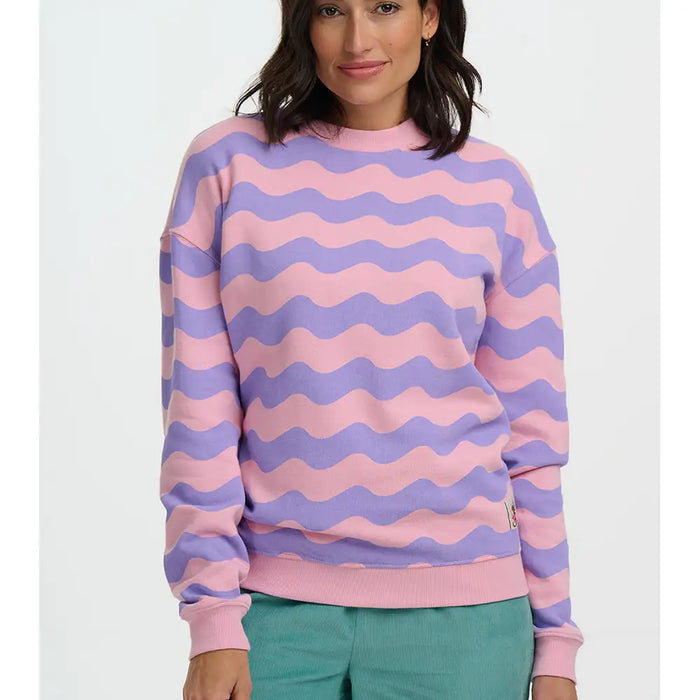 Person wearing a pink and purple striped sweater on a white background