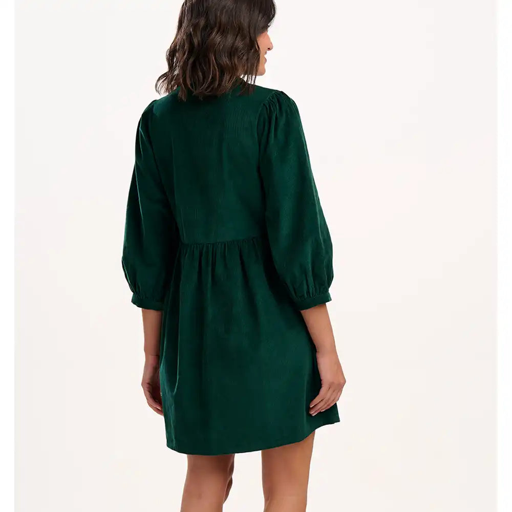 Green dress worn by a person on a white background