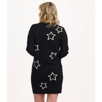 Black dress with white star patterns on a plain background