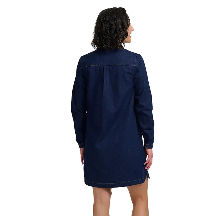 A woman shown from the back wearing a dark navy blue denim shirt dress, photographed against a plain white studio background.