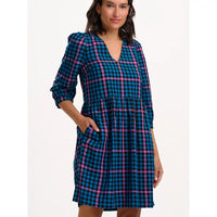 Woman wearing a blue and pink plaid dress on a white background