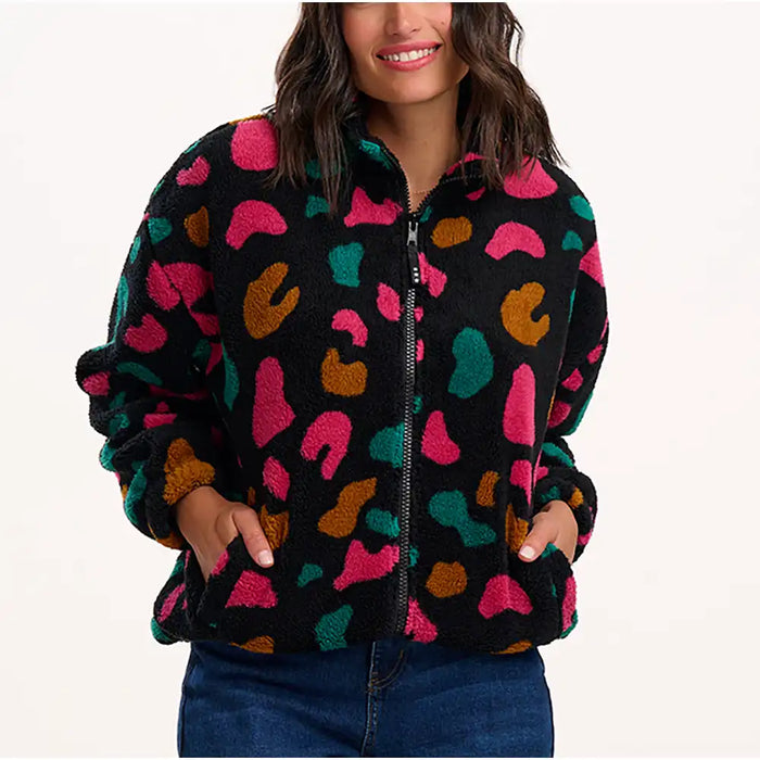 Person wearing a colorful patterned jacket on a white background