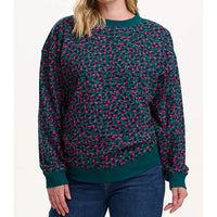 Person wearing a green and pink patterned sweater on a white background
