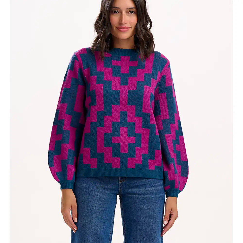 Woman wearing a blue and pink patterned sweater on a white background