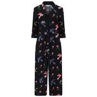 Black pajama set with colorful bird and flower patterns on a white background