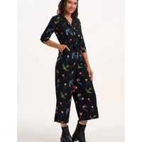 Woman wearing a black patterned jumpsuit on a white background