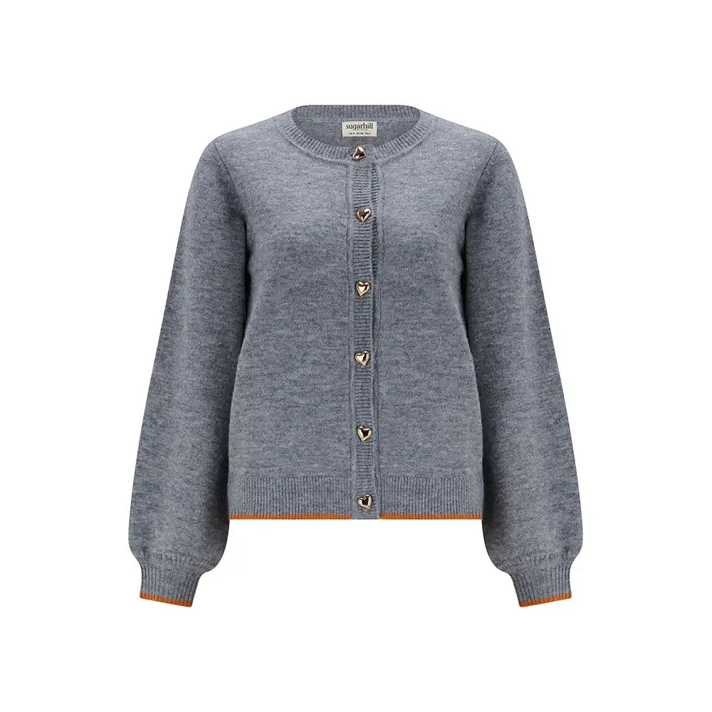 Grey cardigan with gold heart shaped buttons in a white studio environment.