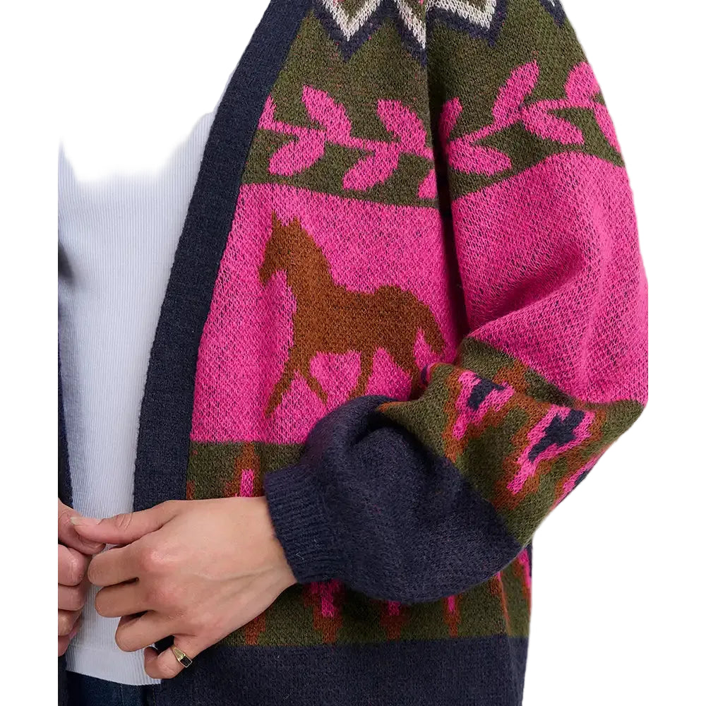 Woman wearing a multi coloured cardign with a running horses motif. The picture is a close up of the front of the cardigan.