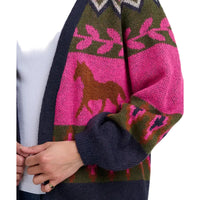 Woman wearing a multi coloured cardign with a running horses motif. The picture is a close up of the front of the cardigan.