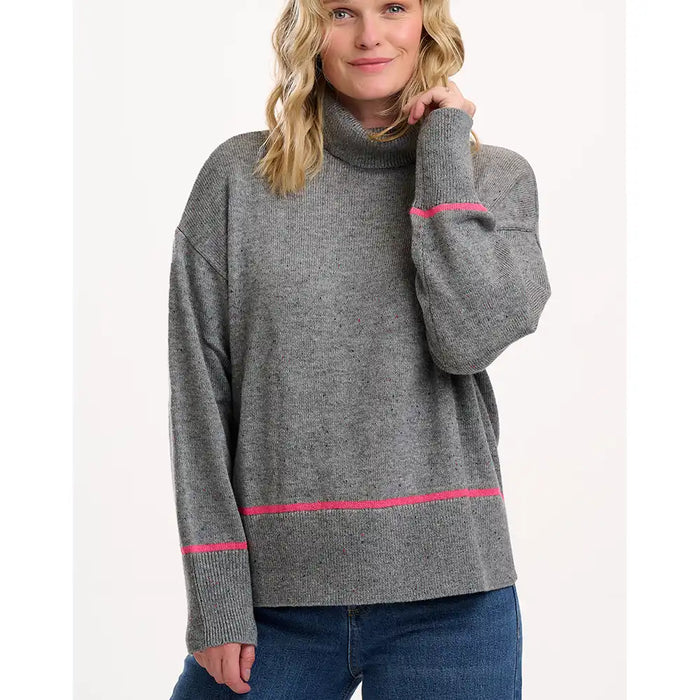 Woman wearing a gray sweater with pink accents on a white background