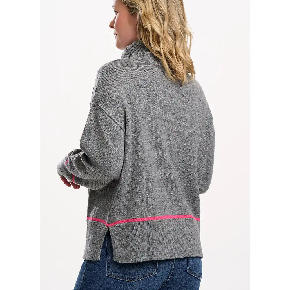 Woman wearing a gray jacket with pink accents on a white background