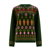 A dark green knit sweater featuring a colorful winter vegetable pattern with carrots, radishes, and flowers across the chest and shoulders, set against a plain white background.