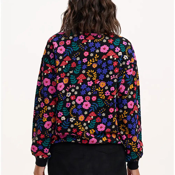 Person wearing a colorful floral-patterned jacket on a white background