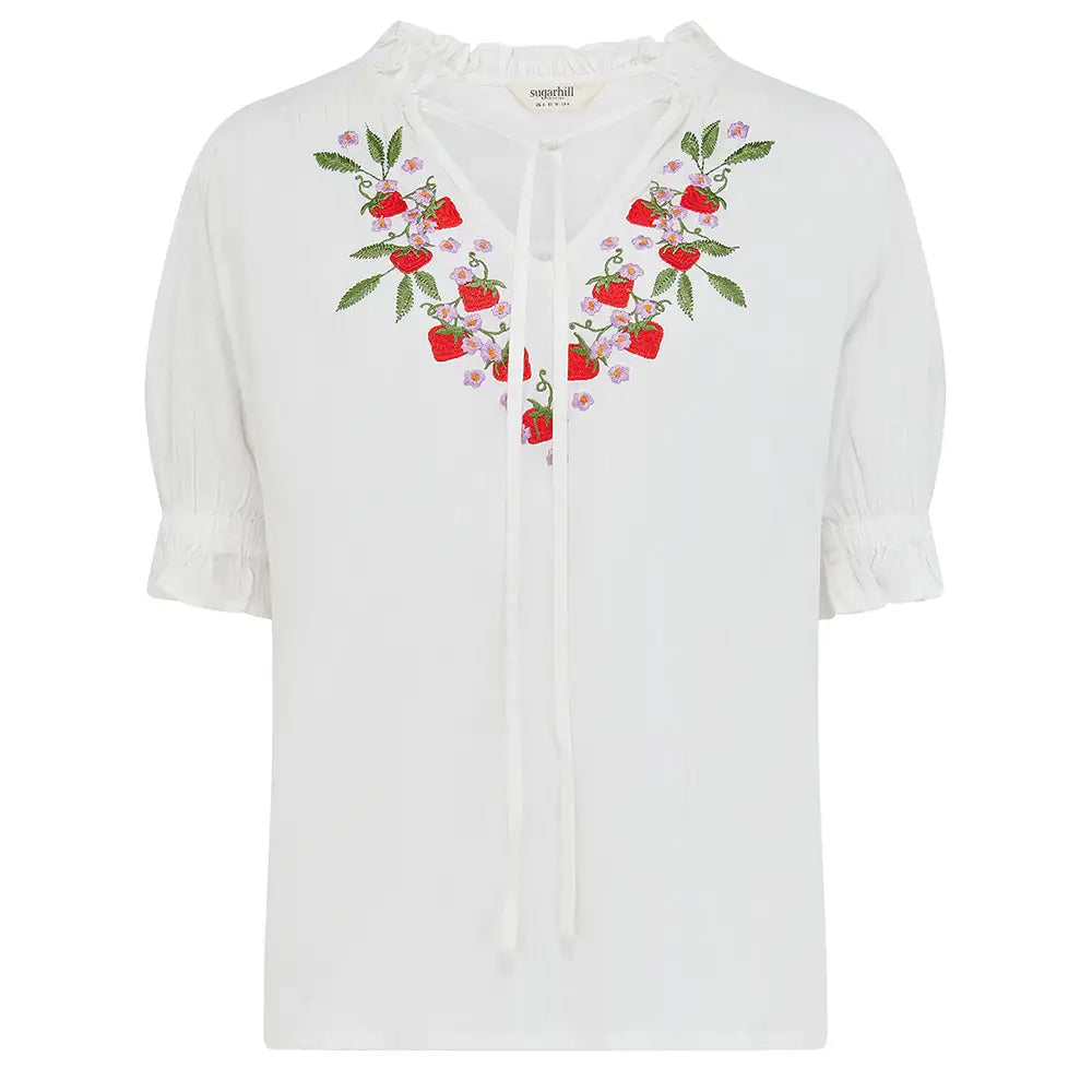 White blouse with floral embroidery on a white background