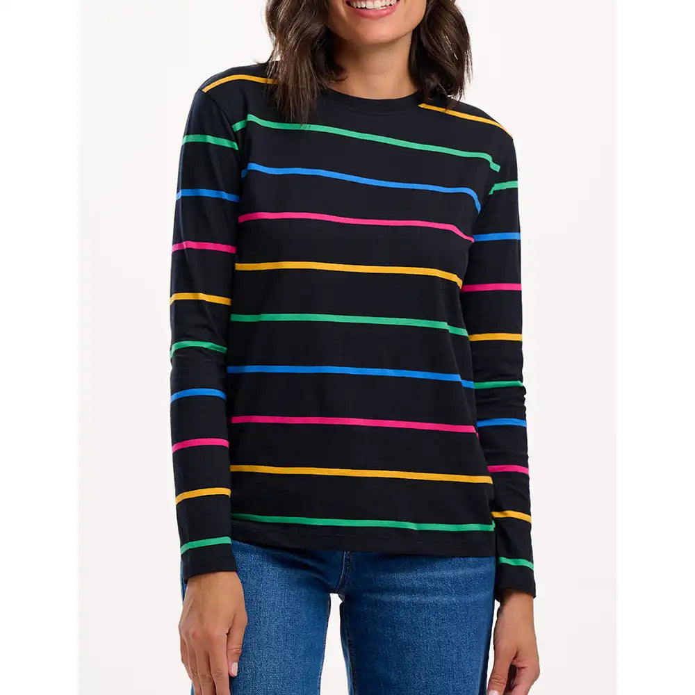 Woman wearing a black long-sleeve shirt with colorful stripes on a white background