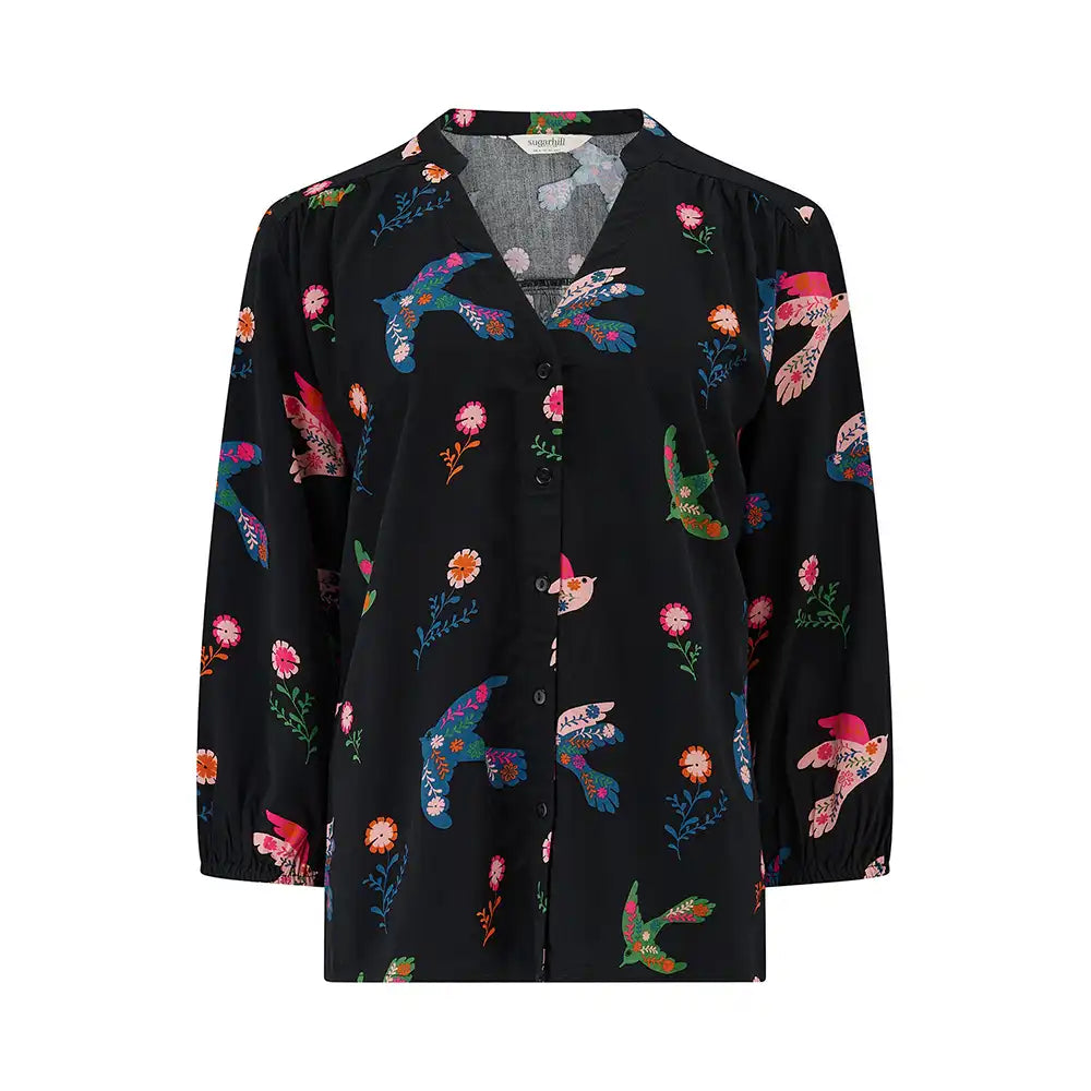 Black blouse with colorful bird pattern on a white background