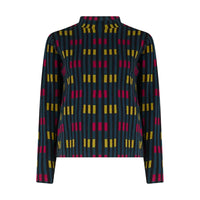 A long-sleeve turtle neck top featuring a geometric pattern of vertical dark blue stripes with yellow and magenta rectangular blocks, shown against a plain white background.
