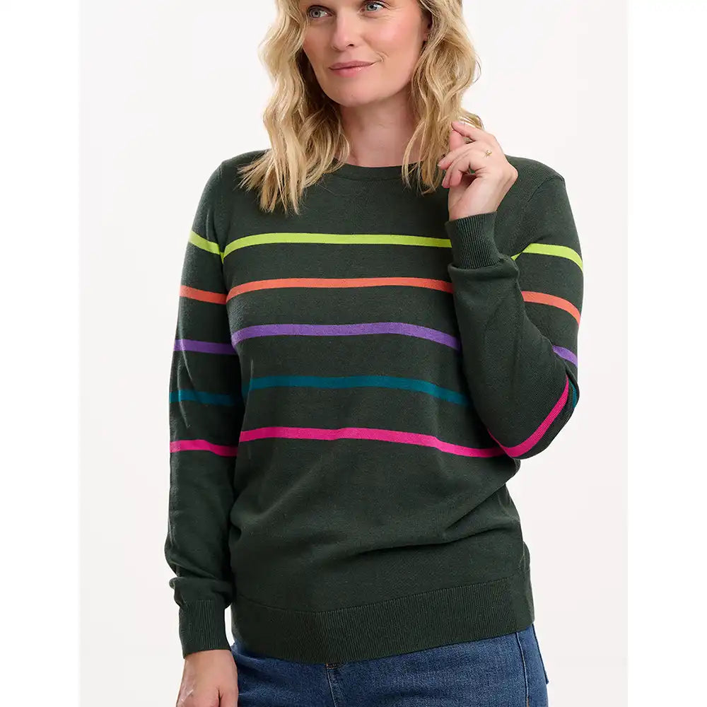 Woman wearing a green sweater with colorful horizontal stripes on a white background