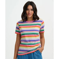 Woman wearing a colorful striped t-shirt on a plain background