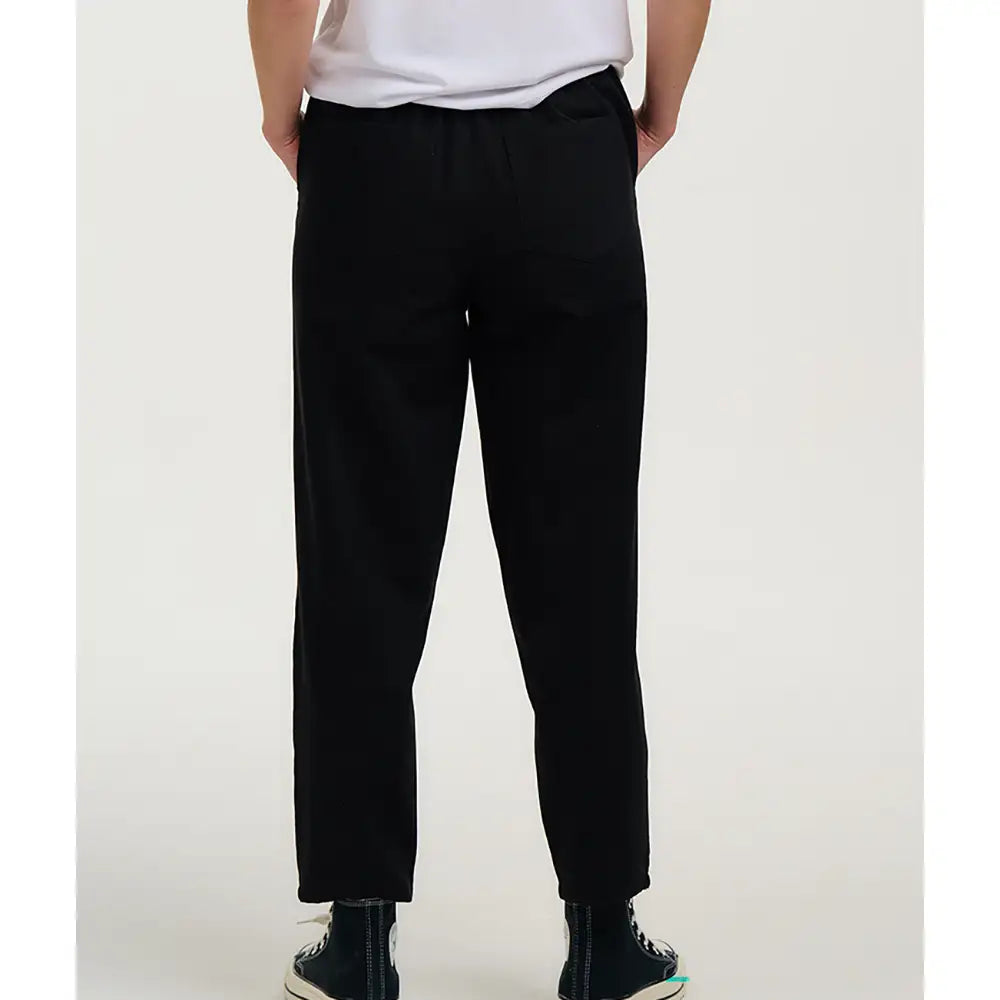 Person wearing black pants on a white background