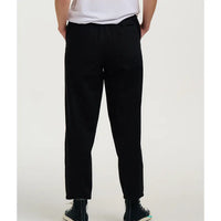 Person wearing black pants on a white background