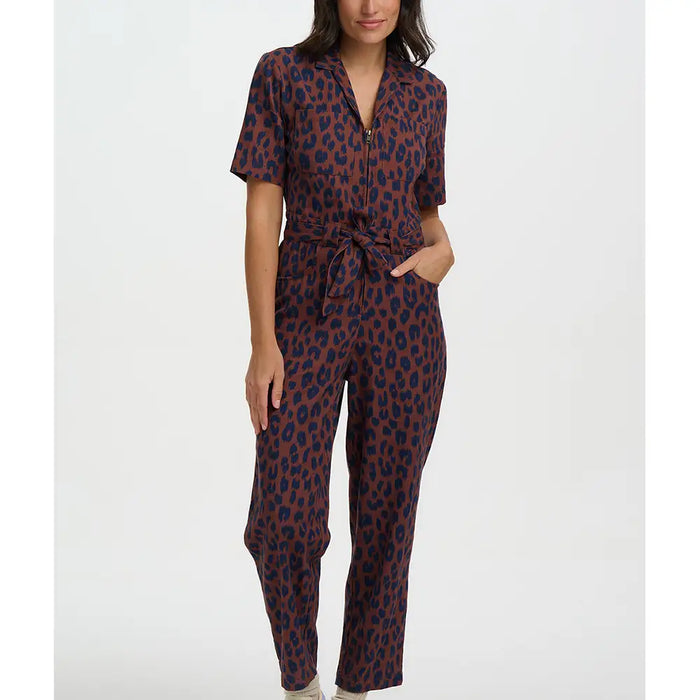 Woman wearing a leopard print jumpsuit on a white background