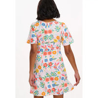 Woman wearing a colorful floral dress on a white background