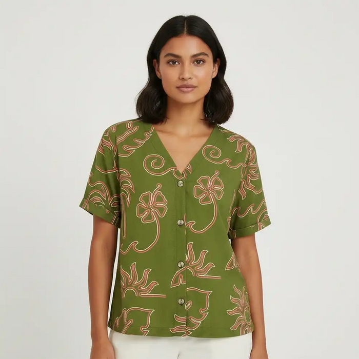Woman wearing a green patterned shirt on a white background