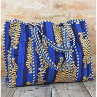Blue and yellow patterned bag on a wooden surface with a rustic background