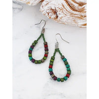 Colorful beaded earrings on a marble surface