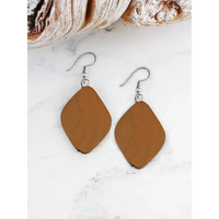 Brown teardrop earrings on a white marble surface