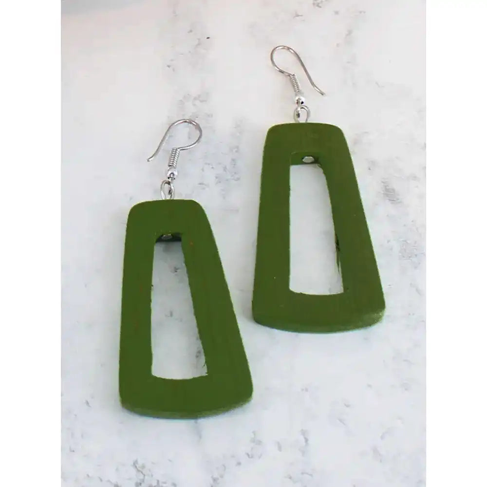 Green earrings on a marble surface