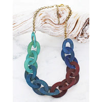 Necklace with blue and red chain links on a white background