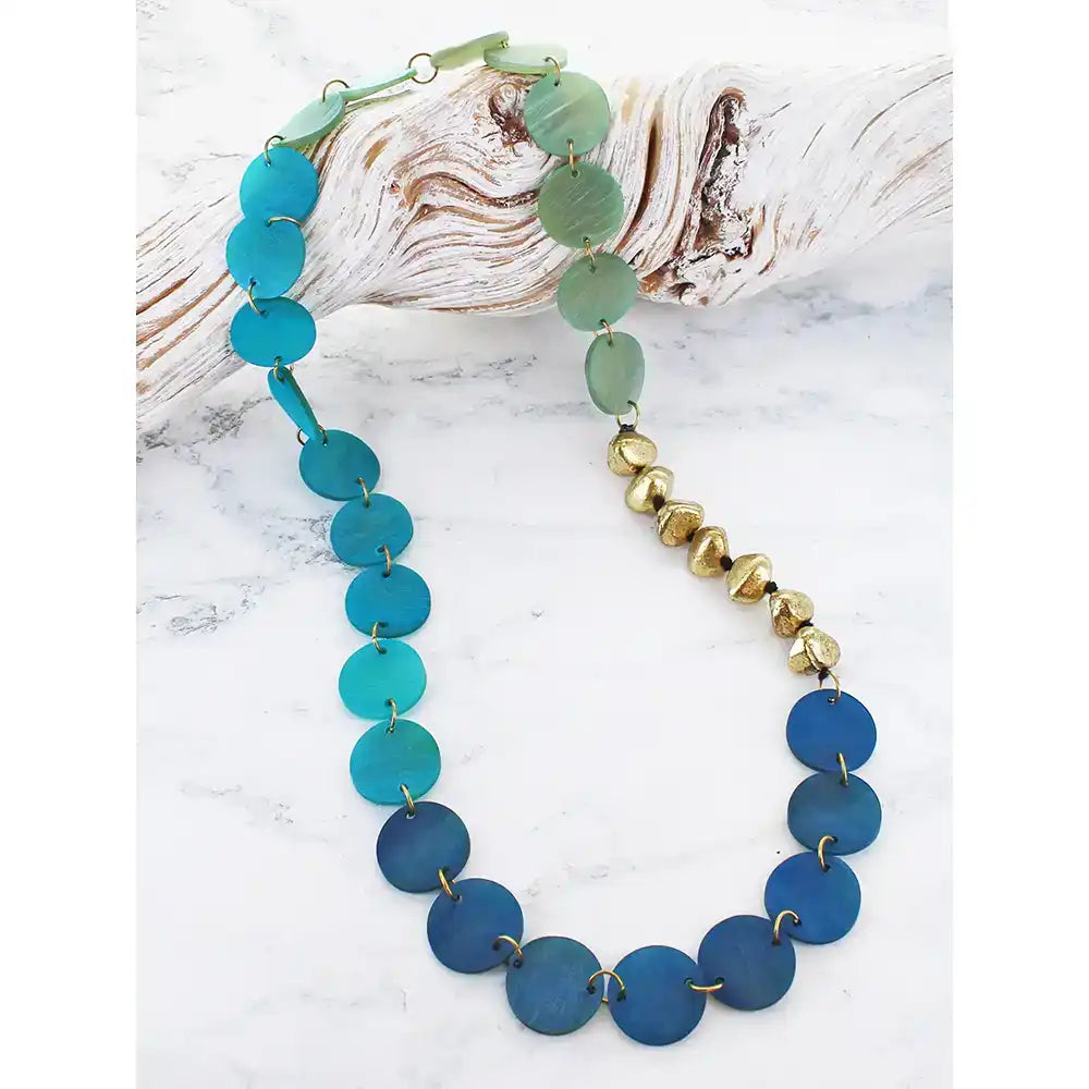 Necklace with blue and green beads on a white background
