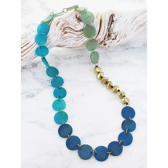 Necklace with blue and green beads on a white background