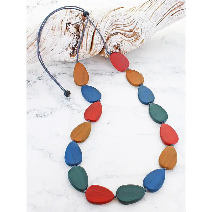 Colorful necklace with wooden beads on a white background