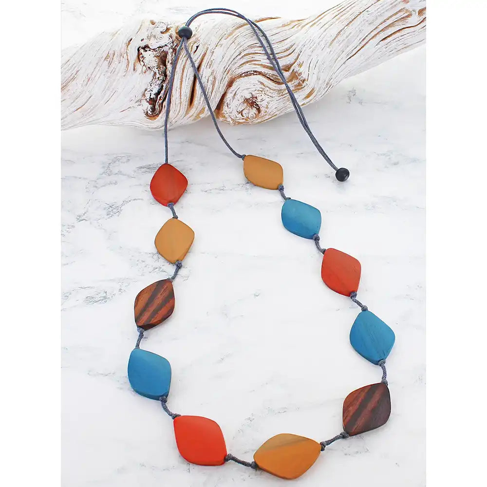 Necklace with colorful beads on a white marble surface