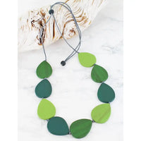 Necklace with green leaf-shaped beads on a white background