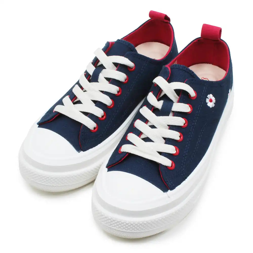 Navy low top sneakers with flower embroidery on white background.