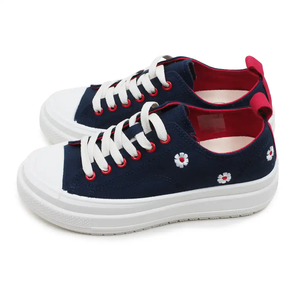 Navy blue sneakers with white laces and red accents on a white background